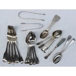 Assorted silver flatwares including spoons, tongs, butter knife, table forks, dessert spoons,