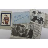 An autograph sheet signed Stan Laurel and Oliver Hardy in blue pen