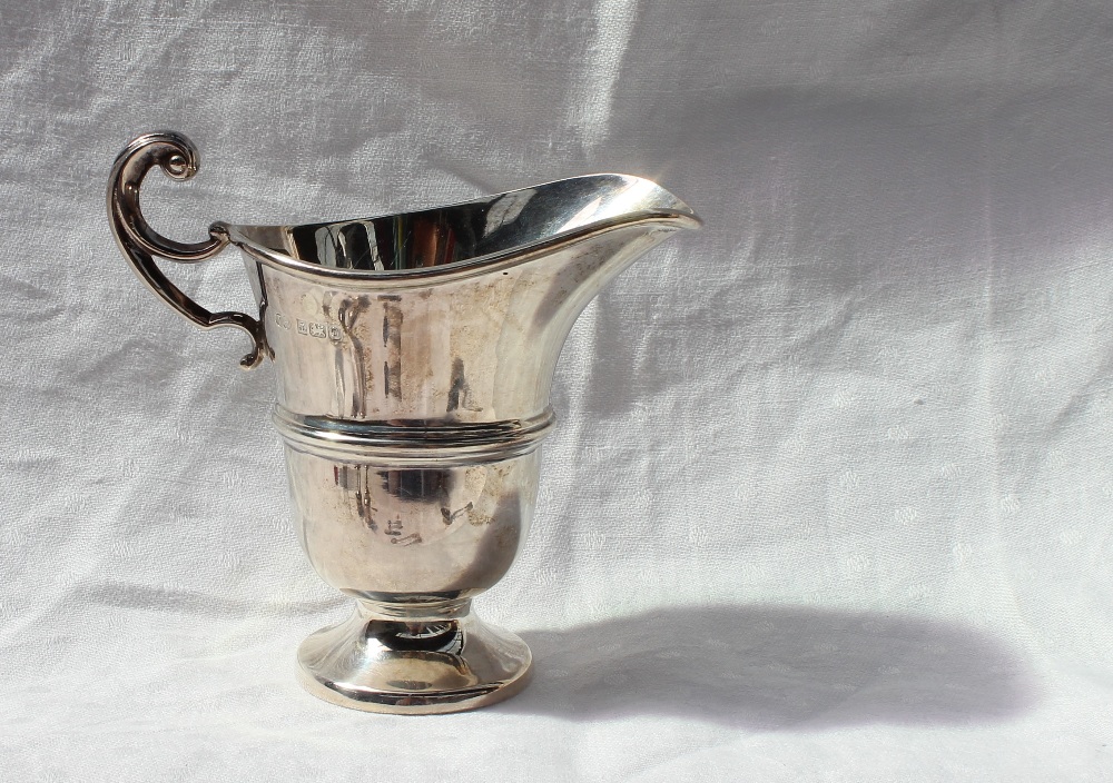 An Elizabeth II silver cream jug of helmet shape, with a ring turned body on a spreading foot, - Image 4 of 7