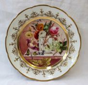 A Nantgarw porcelain plate with a scalloped edge, the border with gilt flower heads and leaves,