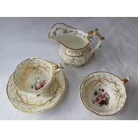 A 19th century English porcelain trio decorated with a spray of garden flowers and gilt roots,
