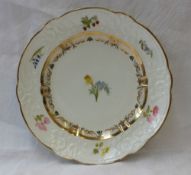 A Swansea porcelain plate, the scalloped rim with a gilt line decoration,
