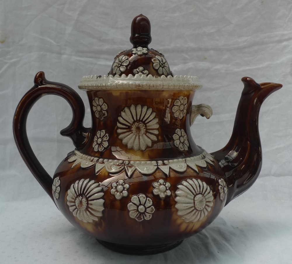 A 19th century pottery bargeware tea pot, with a treacle brown glaze,