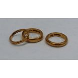 Three 22ct yellow gold wedding bands, approximately 15 grams, sizes L,