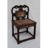 A Chinese hardwood and marble inset chair the back carved with scrolls, leaves and fruit,