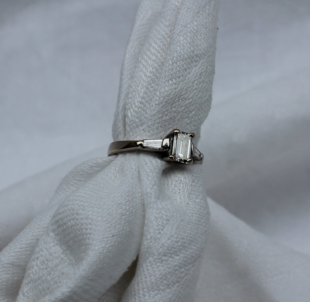 A solitaire diamond ring, the emerald cut diamond measuring 5mm x 4mm x 2mm, - Image 5 of 7