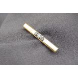 A yellow metal bar brooch,