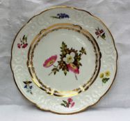 A Swansea porcelain plate, the scalloped moulded border decorated with sprays of garden flowers,