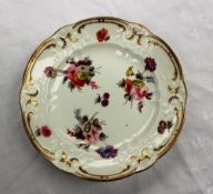 A Swansea porcelain plate with a moulded gilt decorated border, with single flower heads,