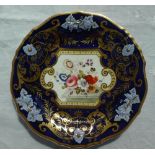 A 19th century English porcelain plate with a thick gilt rim and royal blue ground with raised vine