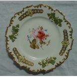 A 19th century English porcelain plate with a castellated rim, with raised vine leaves and grapes,
