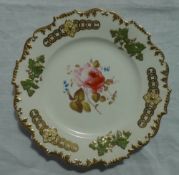 A 19th century English porcelain plate with a castellated rim, with raised vine leaves and grapes,