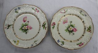 A pair of Swansea porcelain plates with a scalloped edge with a moulded border painted with sprays
