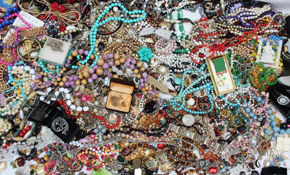 A large quantity of costume jewellery including necklaces, brooches, rings, bead necklaces, bangles,