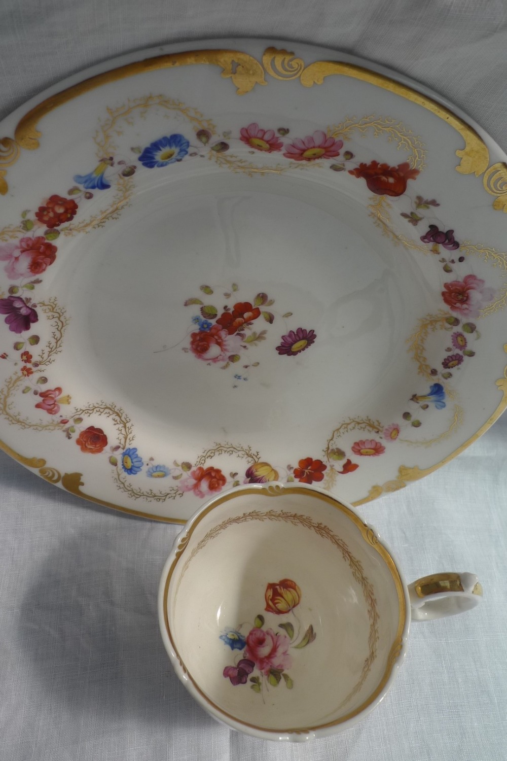 A 19th century English porcelain plate, the edge with gilt scrolling decoration, - Image 2 of 3
