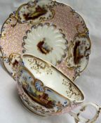 A 19th century English porcelain tea cup and saucer, painted with vignettes of cottages,