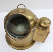 A brass binnacle cased ships compass, the domed cover with ring carrying handle,