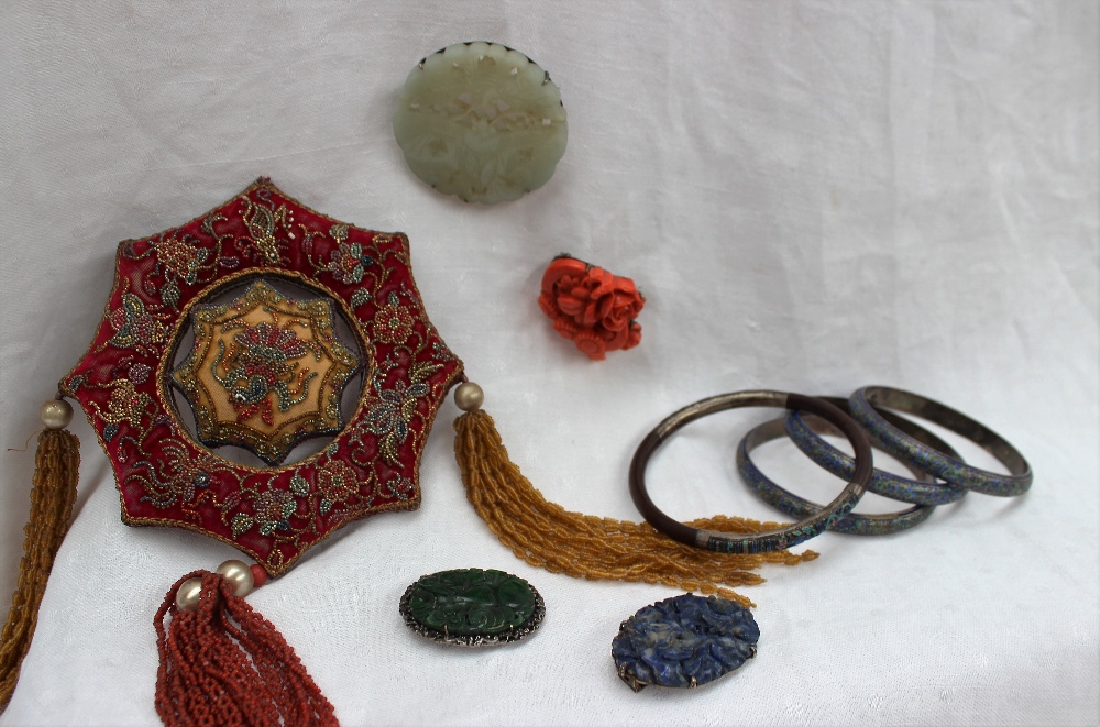 A set of three champleve enamel bangles together with another bangle, a jade brooch, coral brooch,