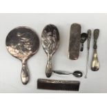 A Chinese white metal part dressing table set including a hand mirror, hair brush, clothes brush,