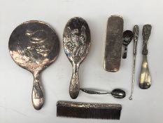 A Chinese white metal part dressing table set including a hand mirror, hair brush, clothes brush,