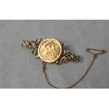 An Elizabeth II gold half sovereign dated 1982, in a 9ct yellow gold brooch mount,