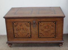 An 18th century oak coffer, the rectangular top inlaid with stars and shells,