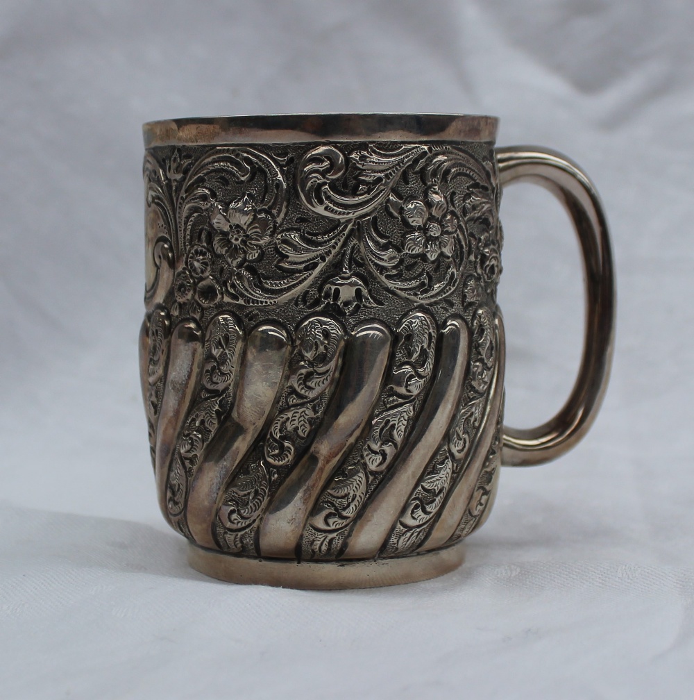 A late Victorian silver christening mug, embossed with flowers, leaves and gadrooning, London, 1896,