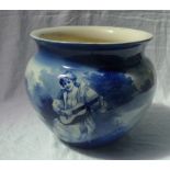 A Royal Doulton blue and white pottery jardiniere decorated with a figure playing a guitar in a
