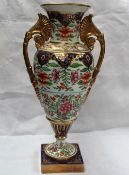 A Swansea porcelain twin handled vase painted with flower heads and leaves,