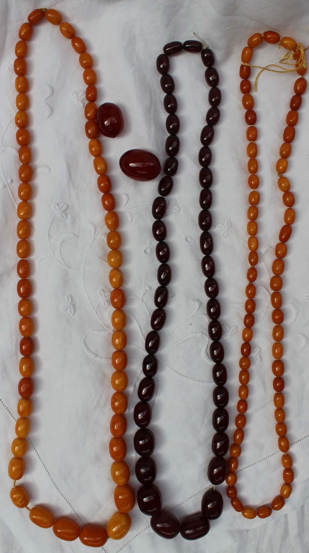 A graduated amber bead necklace, comprising 56 graduated beads from 12mm to 22mm,