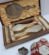 A George V silver cased dressing table set, with line decoration including a hand mirror,