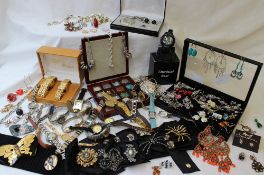 A large quantity of costume jewellery including watches, necklaces, brooches, pendants, earrings,