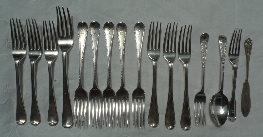 A set of five Victorian silver dessert forks engraved with a family crest, London, 1848,