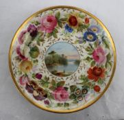 A Swansea porcelain dish of circular form, with a thick gilt rim,