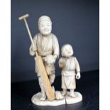 A 19th century Japanese ivory figure group of a man and boy,