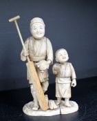 A 19th century Japanese ivory figure group of a man and boy,