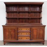 A late Victorian / Edwardian mahogany sideboard with a moulded cornice above a planked back with