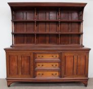 A late Victorian / Edwardian mahogany sideboard with a moulded cornice above a planked back with