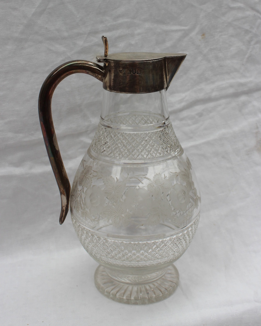 A late Victorian silver topped claret jug,