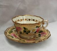 A 19th century English porcelain tea cup and saucer, with a feather edge,