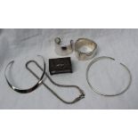 A silver slave bangle together with a silver match box holder, white metal necklaces,