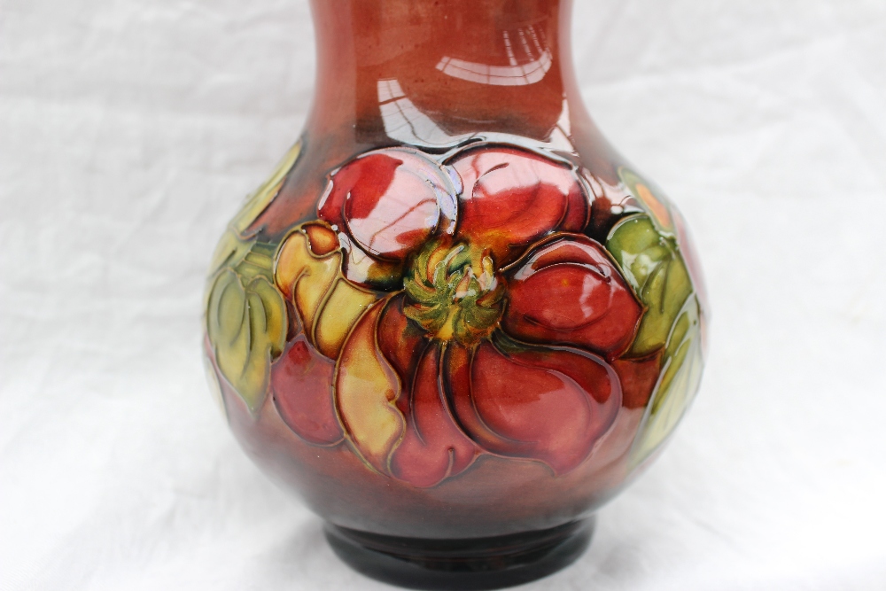 A Moorcroft vase decorated in the clematis pattern, to a graded red ground, - Image 3 of 6