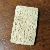 A 19th century Cantonese carved Ivory card case depicting figures in a landscape with trees and