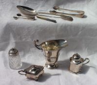 An Elizabeth II silver cream jug of helmet shape, with a ring turned body on a spreading foot,