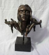 A bronze bust of a maiden, with flowers in her hair, stamped Morris Singer Founders London,