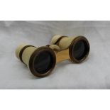 A pair of early 20th century ivory covered opera glasses,