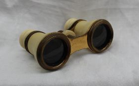 A pair of early 20th century ivory covered opera glasses,