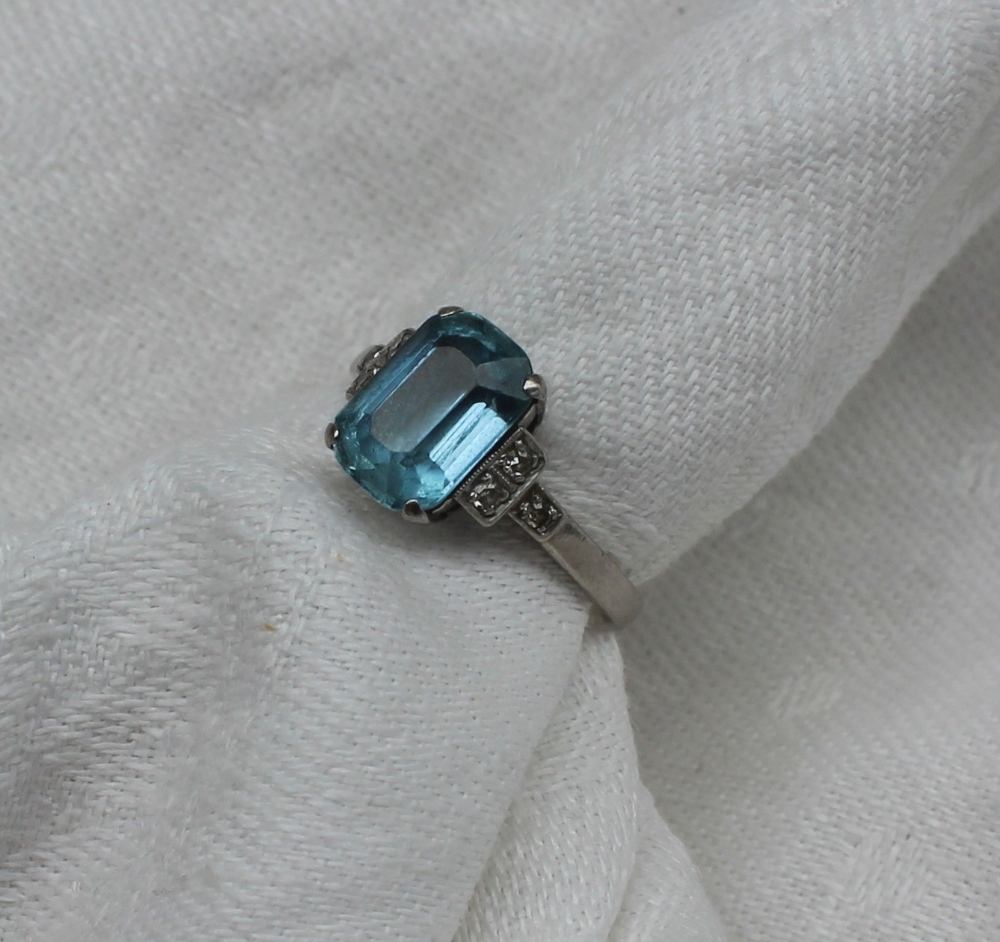 An aquamarine and diamond dress ring, the rectangular faceted aquamarine measuring 10mm x 7mm,