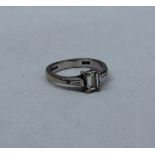 A solitaire diamond ring, the emerald cut diamond measuring 5mm x 4mm x 2mm,