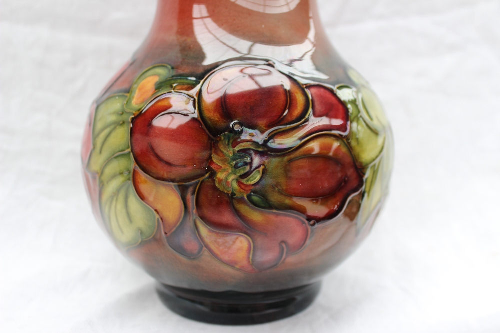 A Moorcroft vase decorated in the clematis pattern, to a graded red ground, - Image 4 of 6